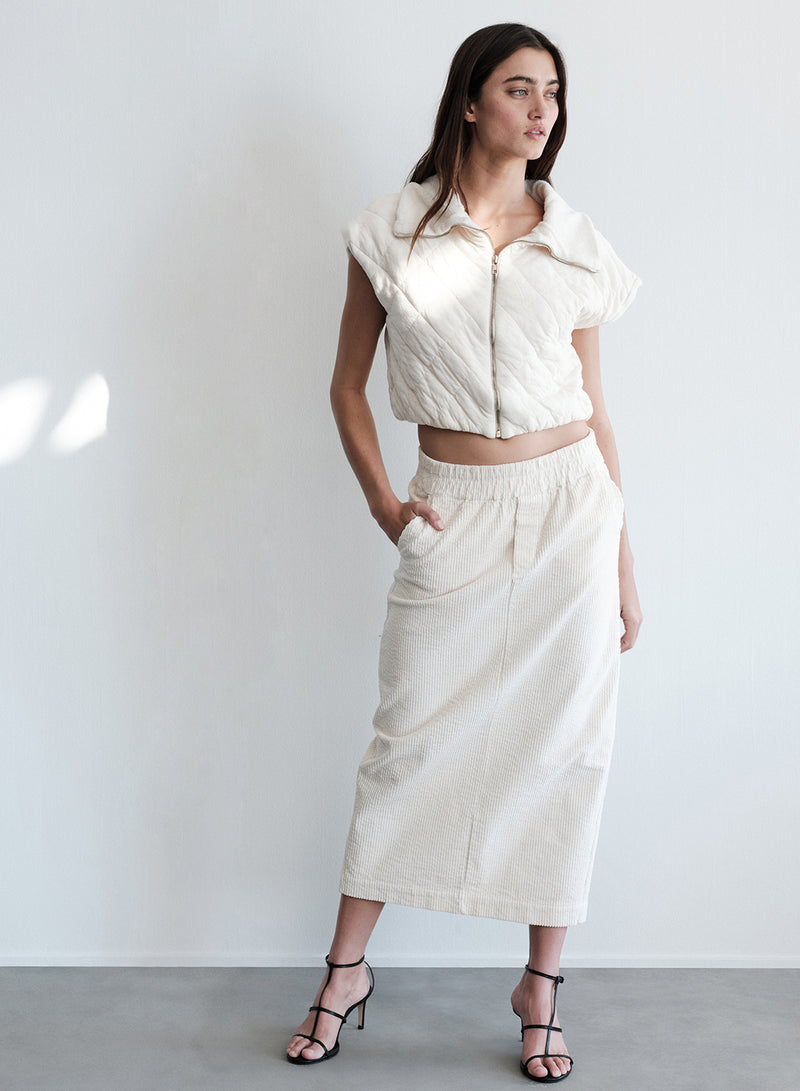 Quilted Cropped Zip Vest in Cream- full length ( model looking away)
