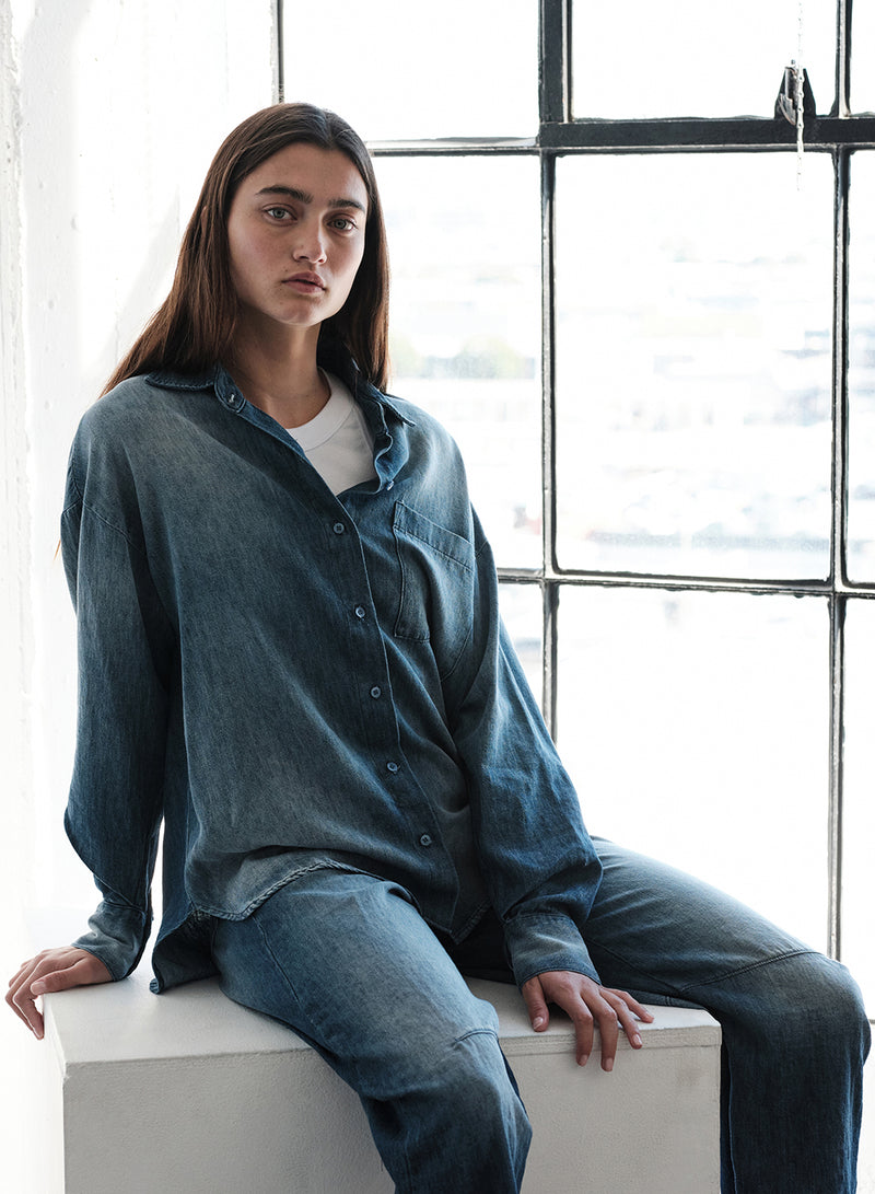 TBS EXCLUSIVE Stonewashed Chambray Oversized Shirt in Medium Wash-model sitting down