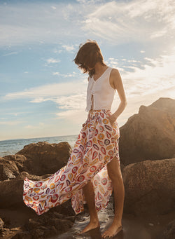 linen double tie front vest in White-model looks down at tad pool wearing a skirt and white top that ties