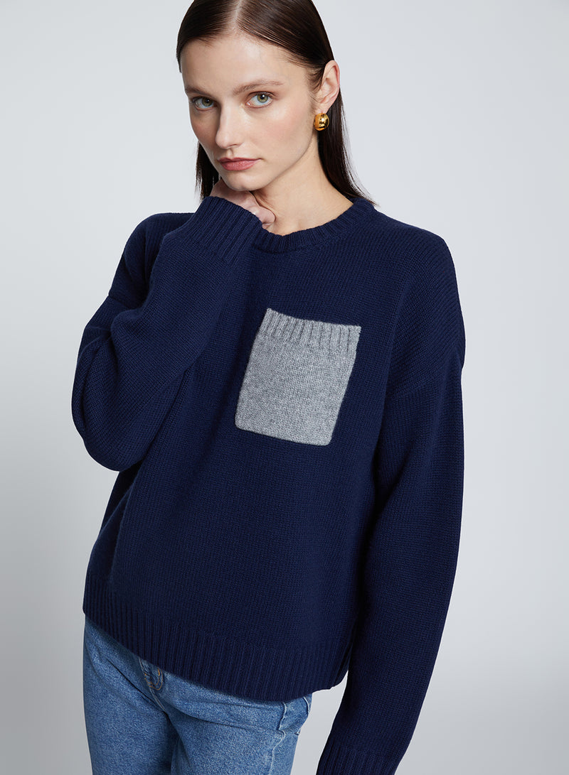 Colorblock Pocket Crew Sweater in New Navy-model is holding her neck 