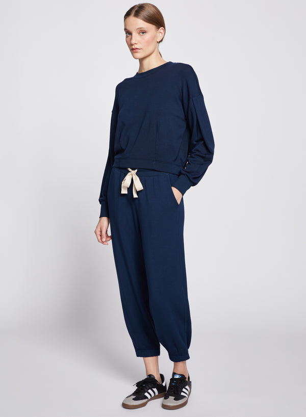 Softest Fleece Pant in New Navy-full view models hand is in her pocket