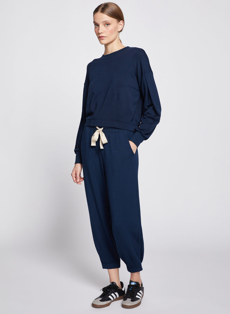 Softest Fleece Pant in New Navy-full view models hand is in her pocket