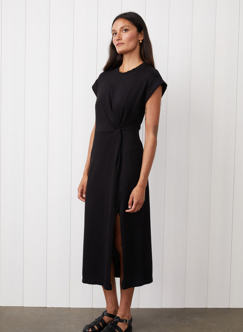 Cloud Jersey Twist Midi Dress in Black - front view with the model looking to the side