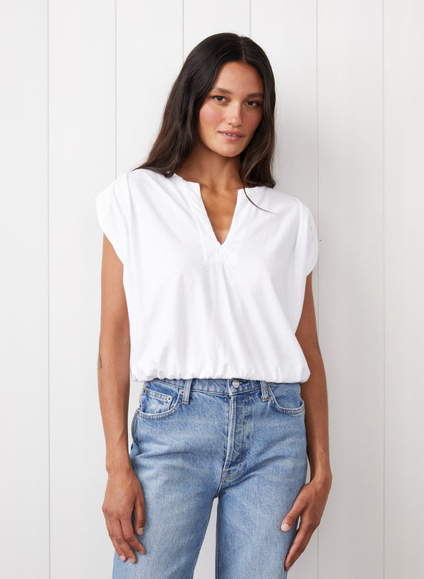 Cloud Jersey Deep V Muscle Top in White - front view with the girl wearing jeans