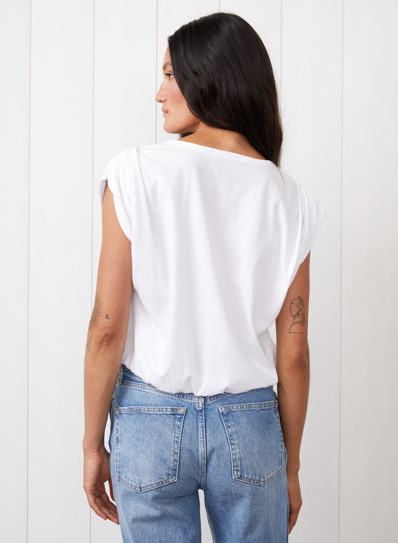 Cloud Jersey Deep V Muscle Top in White - back view with the model's hair swept to the side