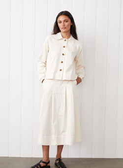 Cava Twill Peacoat in Cream - front view with the girl putting her hands in her pockets