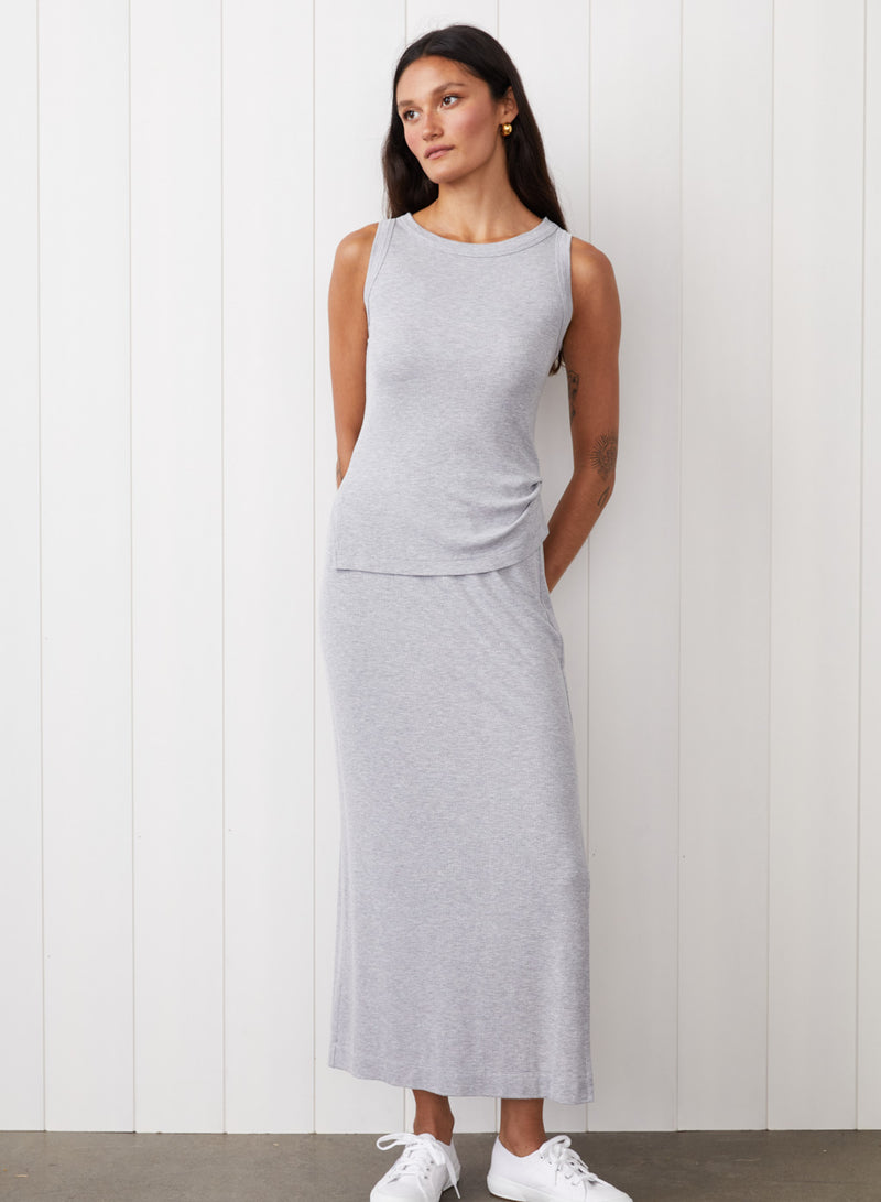 2x1 Fine Rib Asymmetric Ruched Tank in Heather Grey where it's a full body image and the model is looking away. 