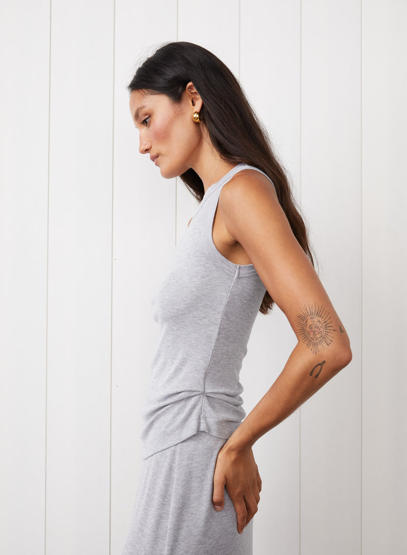 2x1 Fine Rib Asymmetric Ruched Tank in Heather Grey where the model is looking down and arm is on her hip. 