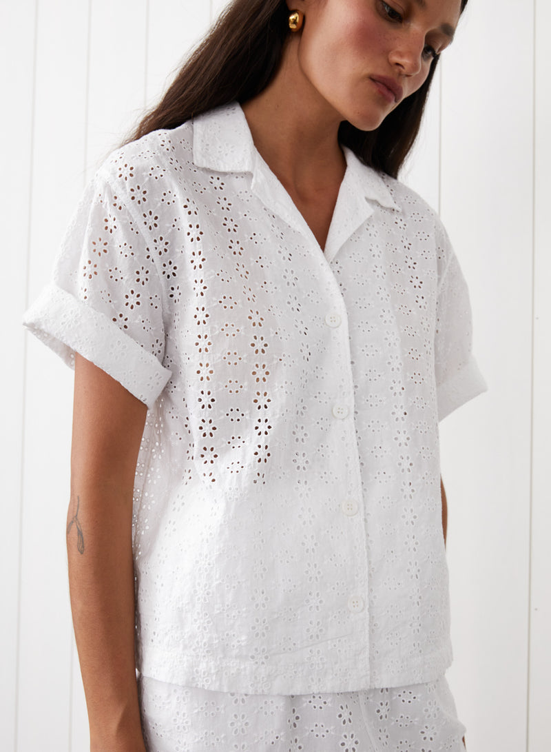 Eyelit Camp Shirt in White - front view with the model looking down