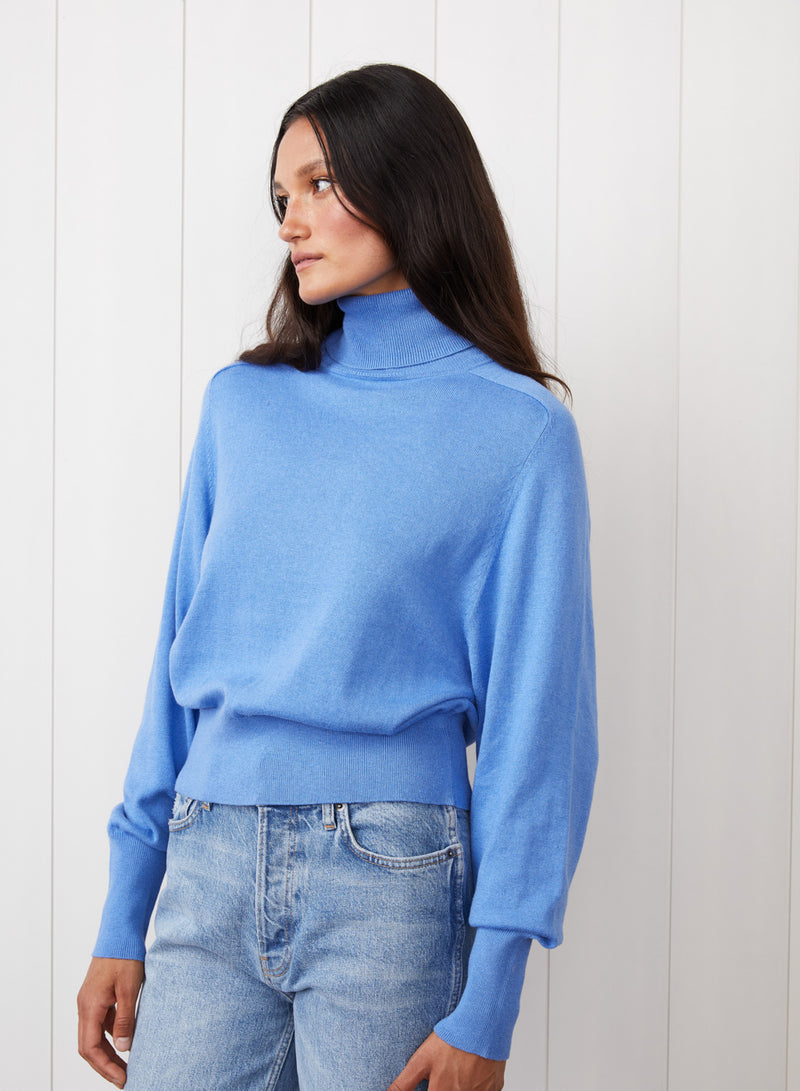 Saddles Shoulder Sweater in Clear Sky - front view with the model looking to the side