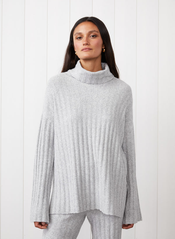 6x6 Rib Turtleneck in Heather Grey - close up to the model wearing the turtleneck and neck facing up more. 