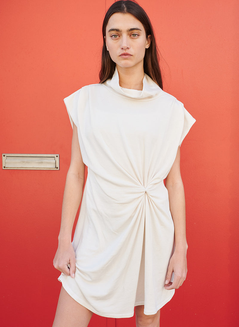Softest Fleece Twist Midi Dress in Cream-model in front of red door